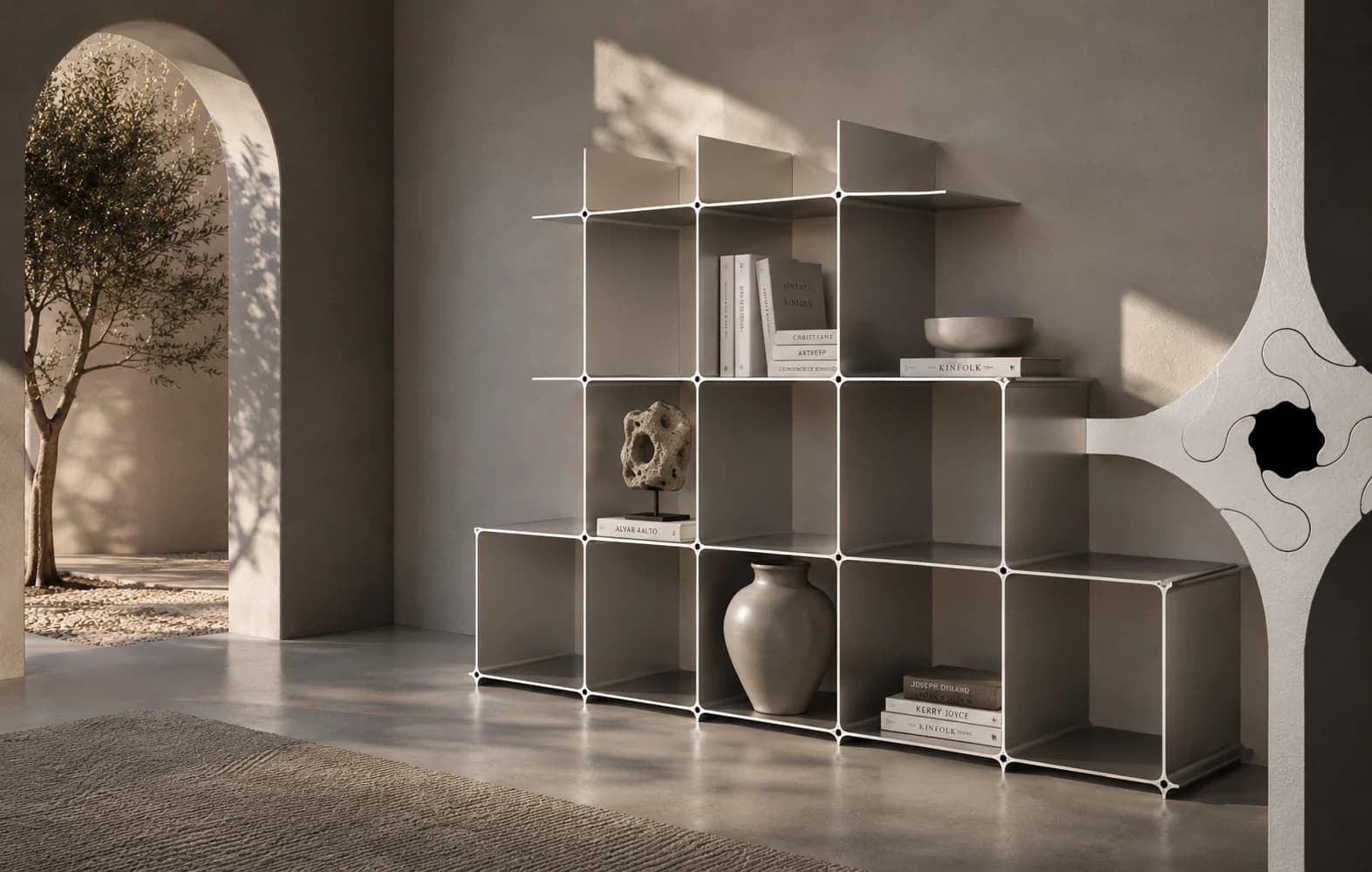 Montique aluminium shelf, stepped build, in a warm room with an arch and olive tree